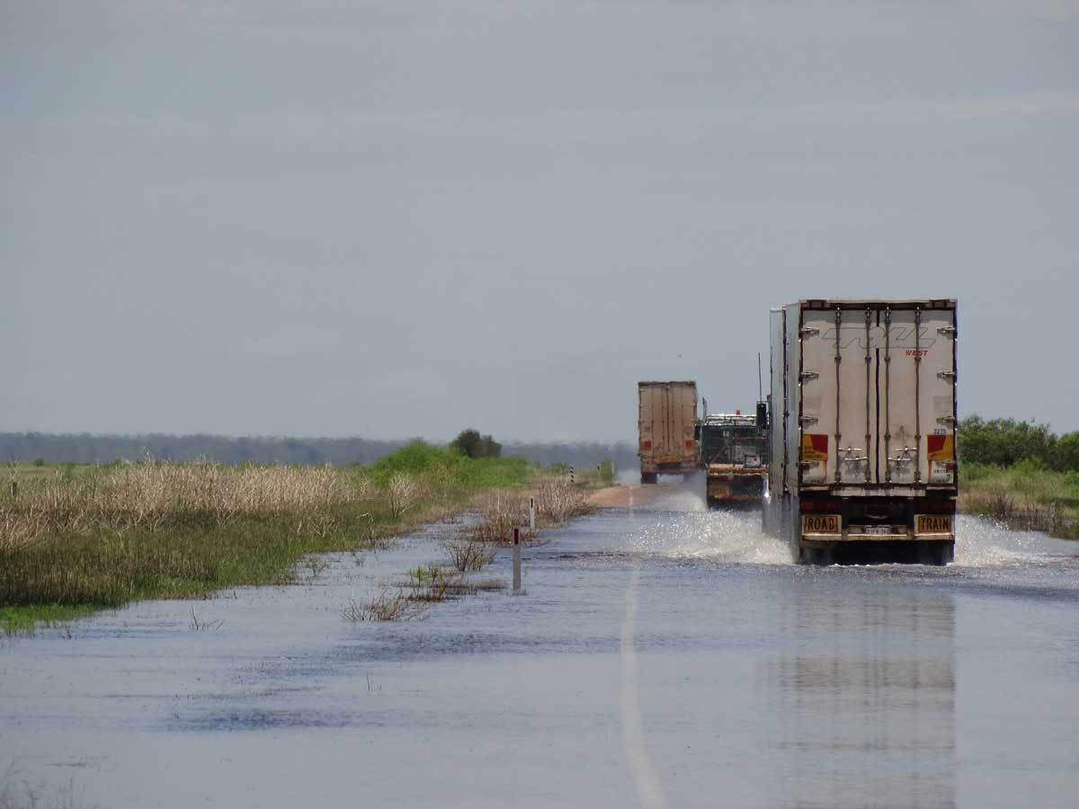 trucks on a flooded highway